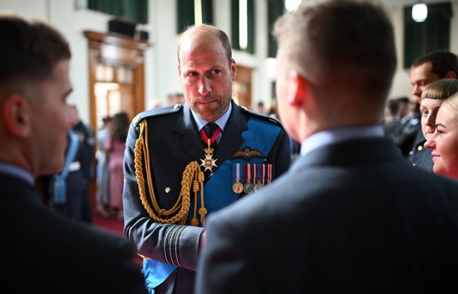 Britain's Prince William, Prince of Wales, sporting a beard, speaks with serving graduates following the Sovereign's Parade at the Royal Air Force (RAF) College in Cranwell, near Sleaford, eastern England, on September 12, 2024. Cadets have undergone up to 24 weeks of intensive training, which prepares them with the skills and knowledge required to set the foundations for a successful career in the RAF. (Photo by Oli SCARFF / POOL / AFP) (Photo by OLI SCARFF/POOL/AFP via Getty Images)