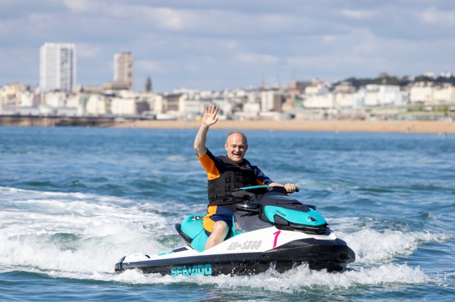 BRIGHTON, ENGLAND - SEPTEMBER 14: Party leader Ed Davey arrives at Liberal Democrat Autumn Conference on a jet ski alongside newly elected MPs on September 14, 2024 in Brighton England. The Liberal Democrats increased their MP headcount from 15 to 72 in the recent general election, a record result for the party. This makes them the third-largest party in the UK Parliament. (Photo by Nicola Tree/Getty Images)