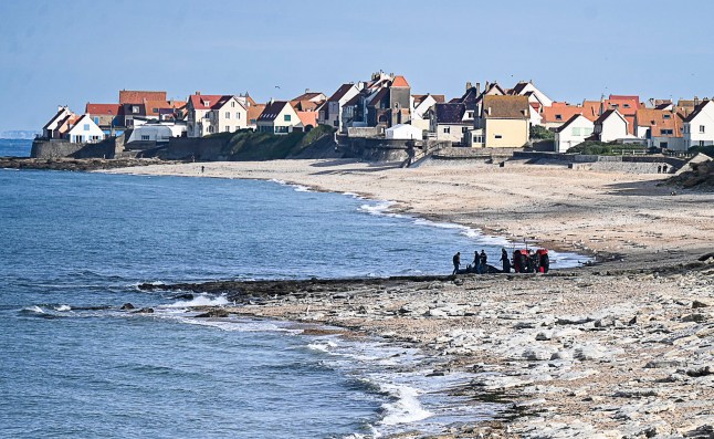 French gendarme use a tractor to pull a damaged migrants' boat after a failed attempt to cross the English Channel that led to the death of 8 people near the beach of Ambleteuse, northern France on September 15, 2024. Eight migrants died when their clandestine boat sank off Ambleteuse (Pas-de-Calais) on September 15, 2024, bringing to over 45 the number of would-be exiles to Britain who died in the Channel in 2024. (Photo by Bernard BARRON / AFP) (Photo by BERNARD BARRON/AFP via Getty Images)