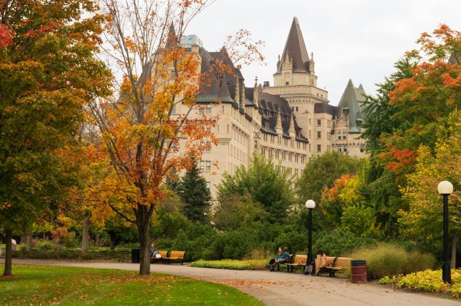 Major's Hill Park autumn red leaves scenery. Fairmont Chateau Laurier in the background.