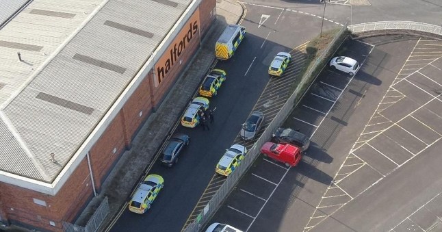 Police cars and vehicles near the site of an illegal rave in Bristol.