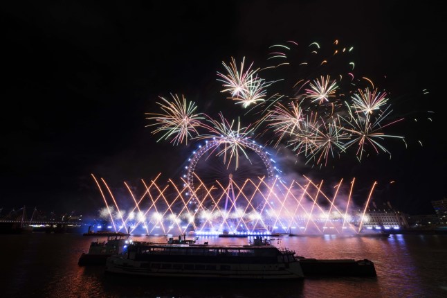 LONDON, UNITED KINGDOM - DECEMBER 31: A view of the firework show over the London Eye during the New Year's celebration in London, United Kingdom on December 31, 2023. (Photo by Rasid Necati Aslim/Anadolu via Getty Images)