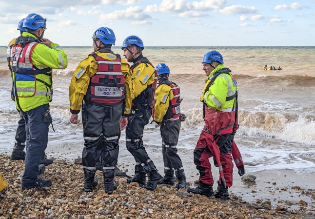 Pictured: Dog walkers and a HM Coastguard rescue team work to save a Pilot Whale stuck on a stretch of beach near Brighstone, Isle of Wight, this morning, Saturday. A desperate rescue operation is underway after a pilot whale became stranded on the Isle of Wight. Two dog walkers spotted the beached mammal - which is reported to seem unwell and weak - early this morning (Sat). The whale, which is around 10ft long and thought to be a youngster, was found on a stretch of beach between Brook and Isle of Wight Pearl near Brighstone. Local residents and specialists alike have arrived on the scene to try and help it. SEE OUR COPY FOR MORE DETAILS. Please byline: Paul Blackley/Solent News ? Paul Blackley/Solent News & Photo Agency UK +44 (0) 2380 458800