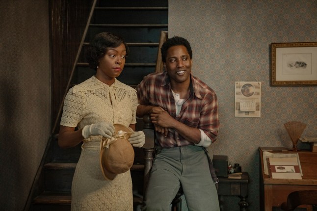 Danielle Deadwyler as Berniece and John David Washington as Boy Willie stood by each other in period specific clothing