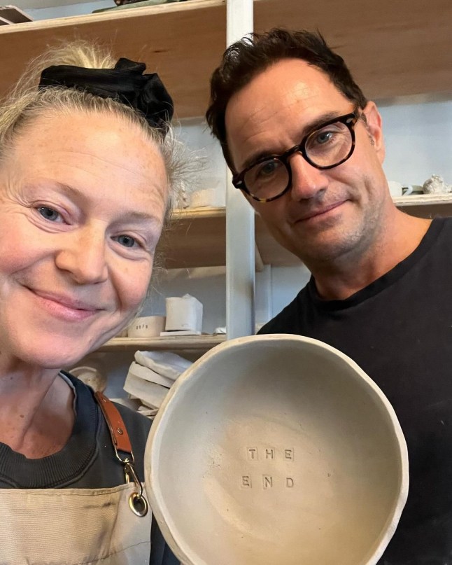 Kellie Bright holding pottery reading 'THE END'