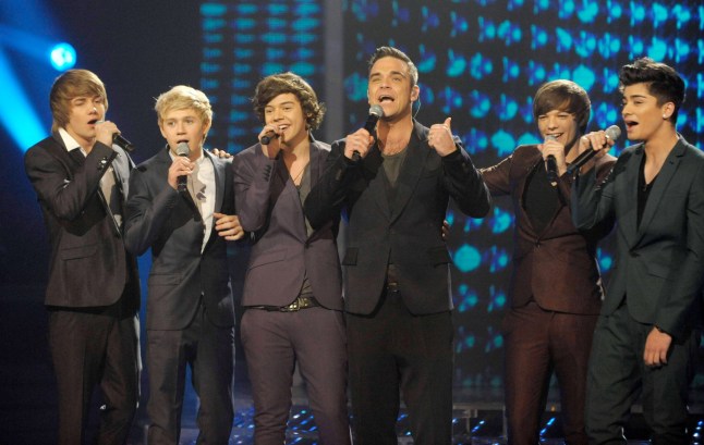 Editorial use only. No book publishing. Mandatory Credit: Photo by Ken McKay/Talkback Thames/REX/Shutterstock (1259790hi) Guest Star Robbie Williams with One Direction - Liam, Niall, Harry, Louis and Zayn 'The X Factor' TV Programme, Live, London, Britain - 11 Dec 2010