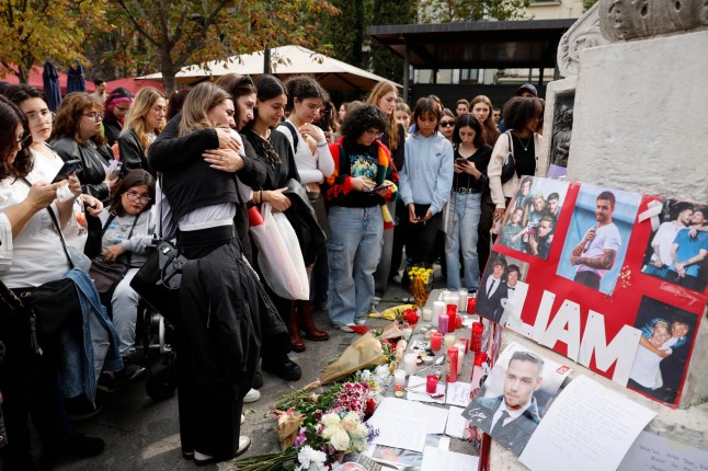 Fans gather at a makeshift memorial to pay tribute to late British singer and former member of pop music boy-band One Direction, Liam Payne, in Madrid on October 20, 2024. Payne, 31, died after falling from a third-floor balcony at a Buenos Aires hotel on October 16, 2024. The circumstances of the pop star's death, however, remain unclear. (Photo by OSCAR DEL POZO / AFP) (Photo by OSCAR DEL POZO/AFP via Getty Images)