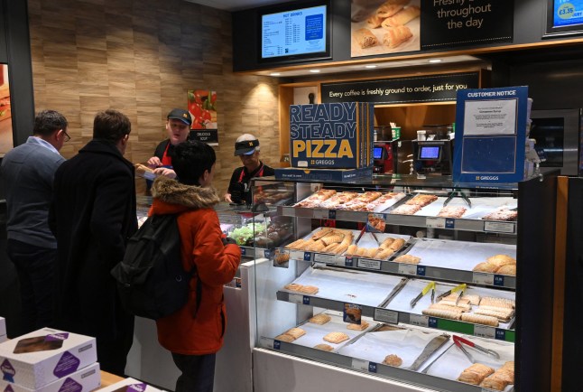 People queue at a counter inside a Greggs bakery in central London on March 5, 2024. British bakery Greggs, famed for its sausage rolls, said Tuesday it logged soaring profit last year, as consumers flocked to the budget chain during a cost-of-living crisis. Net profit leapt almost a fifth to ??142.5 million ($180.6 million) from 2022, Greggs said in a results statement, adding that revenue soared by a similar proportion to ??1.8 billion. (Photo by JUSTIN TALLIS / AFP) (Photo by JUSTIN TALLIS/AFP via Getty Images)