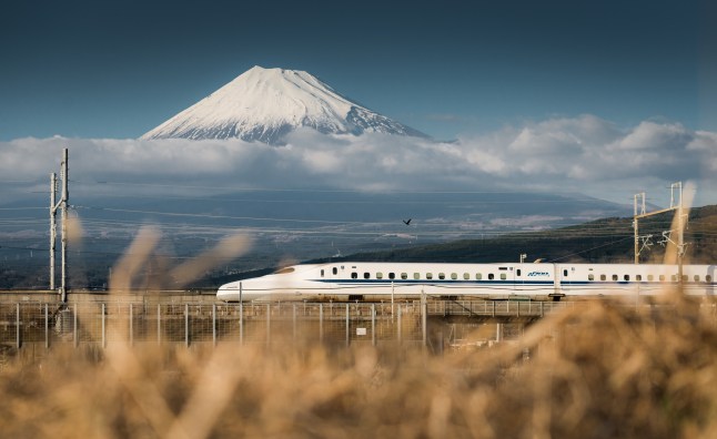 Japanese Shinkansen bullet train running in front of the Mount Fuji in Shizuoka