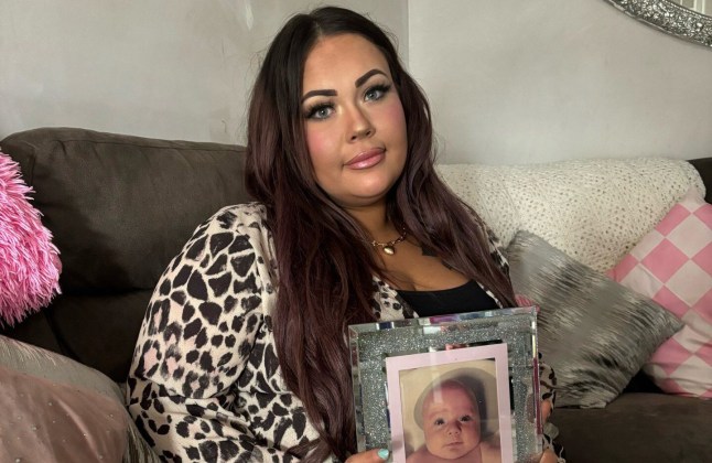 Chloe McCreery sitting on a sofa holding up a photo of Logan in a frame