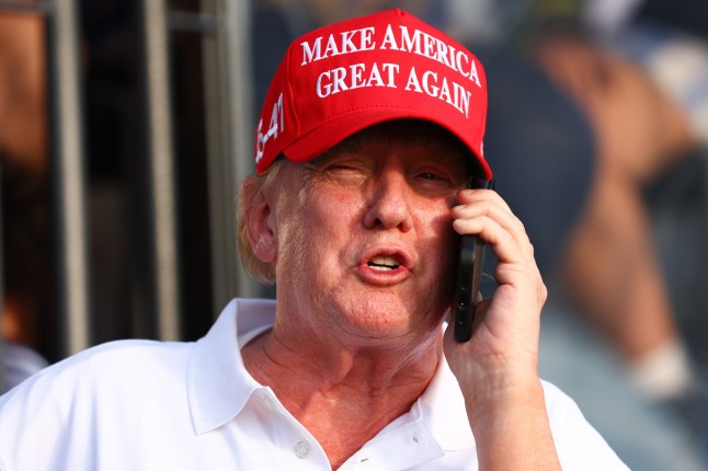 DORAL, FLORIDA - APRIL 07: Former U.S. President Donald Trump speaks on the phone at the 18th green during day three of the LIV Golf Invitational - Miami at Trump National Doral Miami on April 07, 2024 in Doral, Florida. (Photo by Megan Briggs/Getty Images)