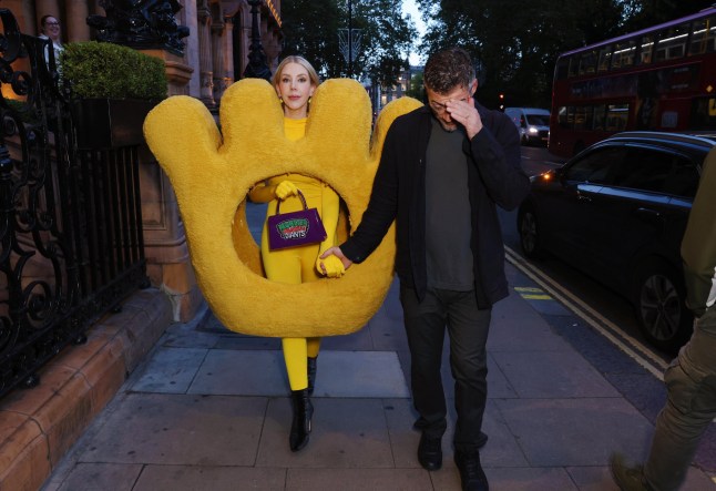 Comedian Katherine Ryan has been pictured taking her Halloween costume to the next level this year ??? dressing up as a Scarily Giant Monster Munch. Release date October 27 2024. Katherine Ryan has been pictured taking her Halloween costume to the next level this year ??? dressing up as a scarily giant Monster Munch. Photos show the 41-year-old comedienne in a fluffy couture outfit inspired by the pickled onion-flavoured snacks, complete with a matching bag, bodysuit, and earrings. Katherine headed out of her hotel in Central London with husband Bobby in tow, leaving the doormen stunned by the giant get-up. With the bespoke fit measuring 130cm from toe-to-toe, the pair were then seen struggling to get her in the back of a black cab with passersby and partygoers in awe of her epic outfit. After the star made headlines in 2023 dressed as a Giant Wotsit, this head-turning costume was created by Walkers Snacks to continue Katherine???s tradition of choosing a Halloween look inspired by her favourite snacks.