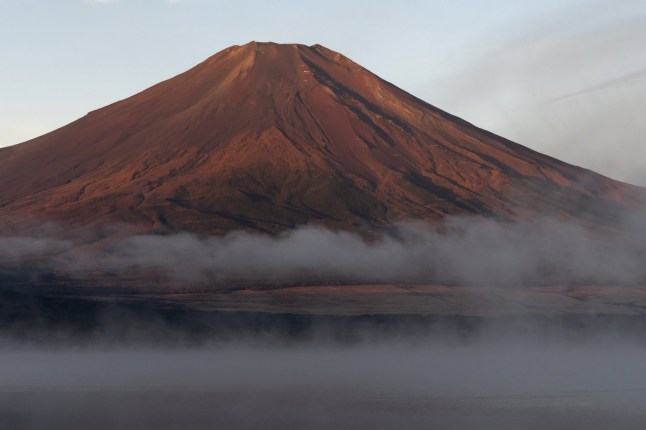 YAMANAKAKO, JAPAN - OCTOBER 31: Mount Fuji is seen on October 31, 2024 in Yamanakako Village, Japan. Japan's iconic Mount Fuji has yet to receive any snowfall this year, marking the latest date without snow since records began 130 years ago. Typically, the mountain's snowcap forms by early October, but unusually high temperatures this summer have delayed its arrival, raising concerns about climate change's impact on weather patterns. (Photo by Tomohiro Ohsumi/Getty Images)