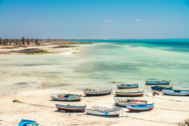 Djerba, Tunisia - May 3, 2022: Djerba, the largest island of North Africa, is a Tunisian gem located in the Gulf of Gabes. Known for its white sandy beaches and distinctive, whitewashed domed houses, it offers a serene landscape with multiple shades of turquoise seas. The Djerban people, culturally distinct from mainland Tunisians, preserve many of their unique traditions and architecture. In 2023, Djerba was designated a UNESCO World Heritage Site, acknowledging its rich history.