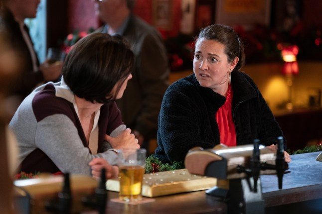 Eve and Stacey stand at the bar of the Vic in EastEnders