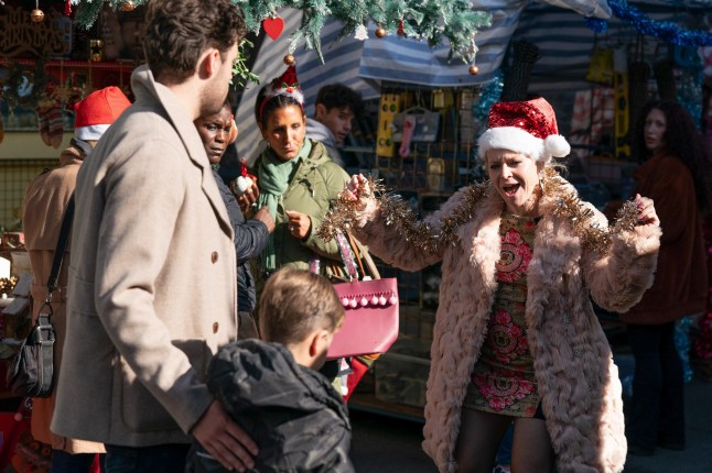 Linda Carter embarrasses sons Johnny and Ollie dressed in a Santa hat in EastEnders