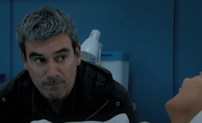 Cain Dingle looks regretfully at Moira in her hospital bed in Emmerdale