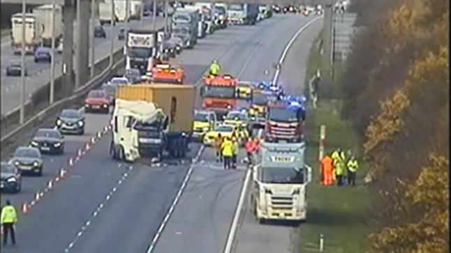 Emergency services and two lorries on the A1M near Huntingdon after a crash with traffic queueing next to the scene.