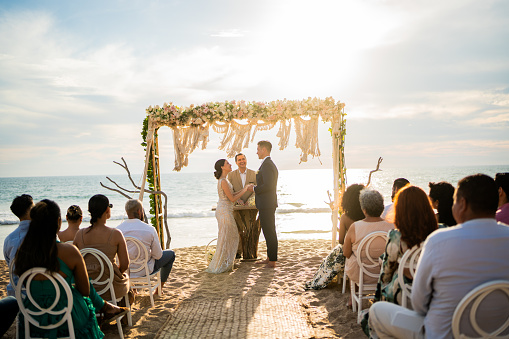 Groom and bride in wedding ceremony on the beach