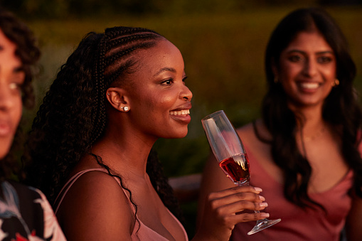 Happy woman drinking champagne at dinner party