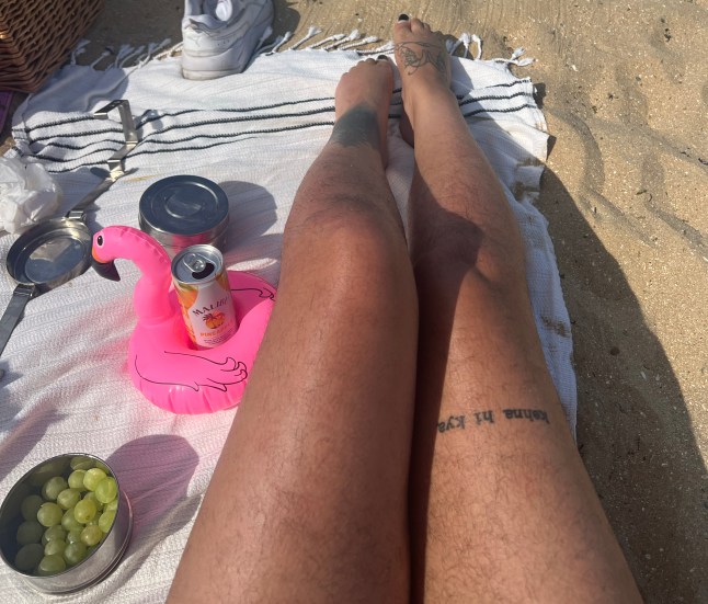 Sharan's bare and hairy legs at a beach