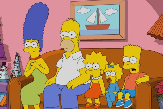 The Simpsons family sat on the sofa looking shocked