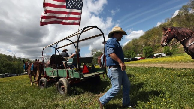 A man walks under the American flag in Kentucky