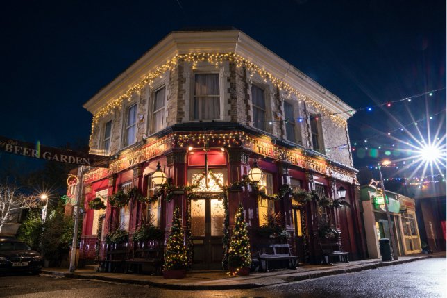 The Queen Vic pub in EastEnders decorated with Christmas lights and trees