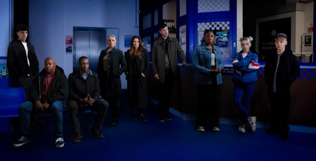 Mason, Ed, Ronnie, Lisa, Carla, Kit, Dee-Dee, Lauren and Max all lined up in the police station as suspects in Coronation Street