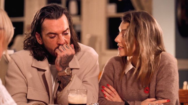 A still of Pete Wicks and Jowita on Strictly sat at a table