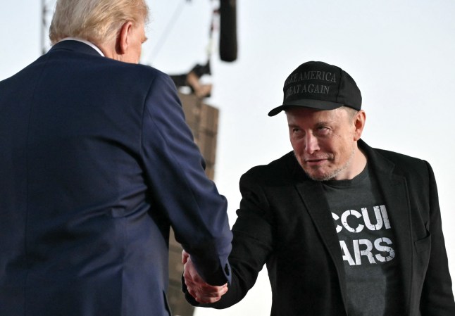 Tesla CEO Elon Musk (R) joins former US President and Republican presidential candidate Donald Trump during a campaign rally at site of his first assassination attempt in Butler, Pennsylvania on October 5, 2024. (Photo by Jim WATSON / AFP) (Photo by JIM WATSON/AFP via Getty Images)