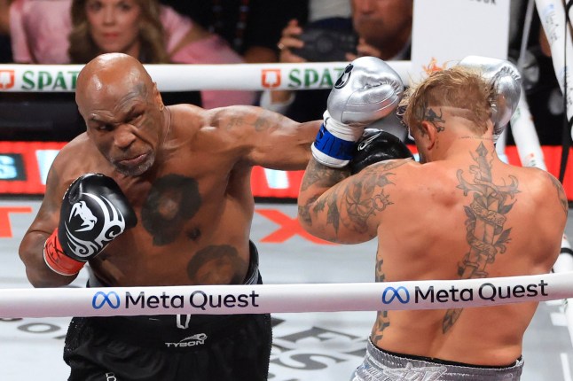 ARLINGTON, TEXAS - NOVEMBER 15: Mike Tyson (L) punches Jake Paul during their heavyweight bout at AT&T Stadium on November 15, 2024 in Arlington, Texas. (Photo by Christian Petersen/Getty Images)