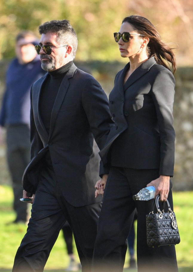 AMERSHAM, ENGLAND - NOVEMBER 20: Simon Cowell and Lauren Silverman attend the funeral for singer Liam Payne, former member of One Direction, on November 20, 2024 in Amersham, England. Former One Direction star Liam Payne's private funeral in Amersham has been widely anticipated to draw celebrities and fans alike, wishing to pay their final respects. The singer died after falling from a hotel balcony in Buenos Aires on October 16. (Photo by Karwai Tang/WireImage)