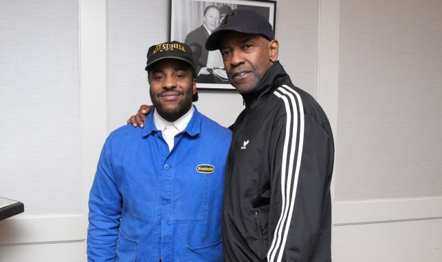 Malcolm Washington in a blue coat stood beside Denzel Washington in a black and white jacket