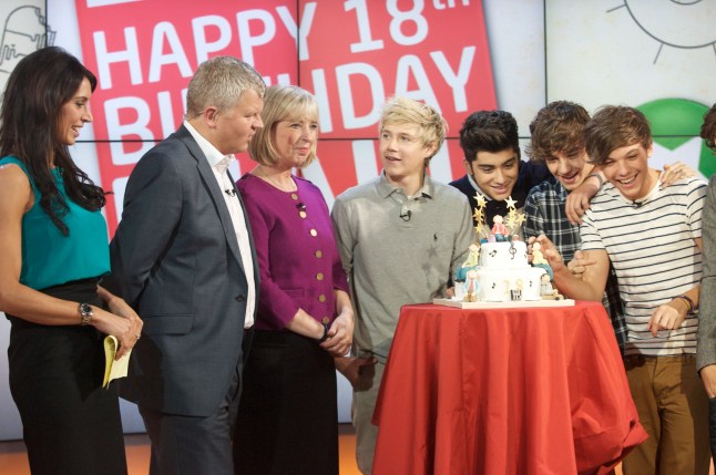 Niall Horan, Zayn Malik, Liam Payne, Louis Tomlinson and Harry Styles with Presenters Christine Bleakley and Adrian Chiles in 2011 around a birthday cake