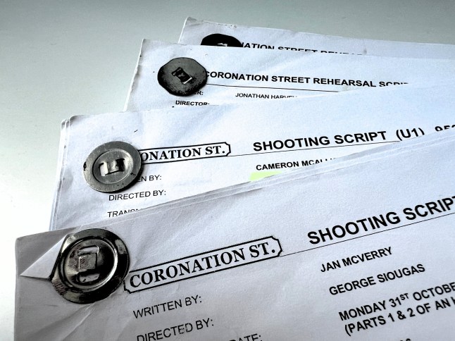 Four Coronation Street shooting and rehearsal scripts on a white table