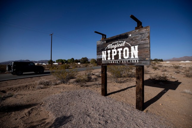 Mandatory Credit: Photo by ETIENNE LAURENT/EPA-EFE/REX/Shutterstock (12918269g) A sign along the road leading to Nipton, California, USA, 29 April 2022. Stuck between a railroad and the Mojave desert, the small town of Nipton, located at the border between California and Nevada, has been sold again, this time to a group from Las Vegas for 2.75 million US dollars. The first time the town was sold for five million dollars in 2017 to a large cannabis company who tried to rebrand it as Magical Nipton, a cannabis retreat. As the company planned to turn Nipton into a cannabis retreat, it spent on infrastructures, installing eco-friendly cabins, tipis and art installations as well as restoring the town's historic structures. However, the project did not come to term and Nipton went back to its previous owner Roxanne Lang. California desert town of Nipton sold again after cannabis retreat project failure, USA - 29 Apr 2022