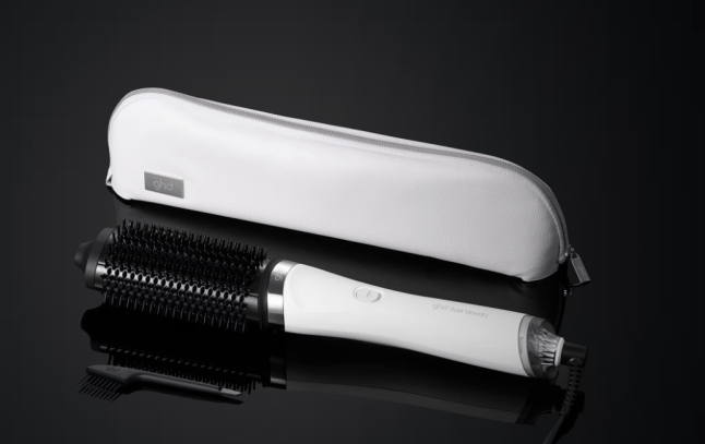 Image of New ghd Duet Blowdry Hair Dryer Brush In Black on a black background.