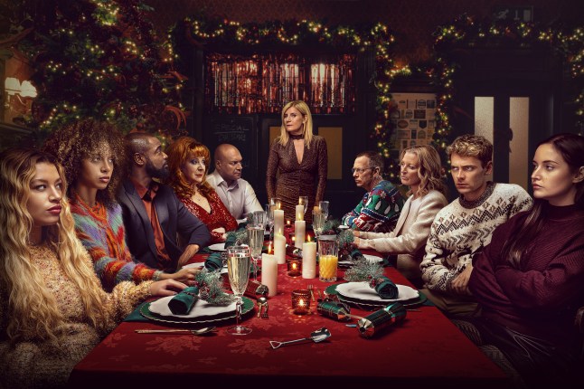 Anna, Gina, Junior, Elaine and George Knight sitting around a Christmas table in EastEnders, looking tensely at Cindy, Ian and Peter Beale and Lauren Branning