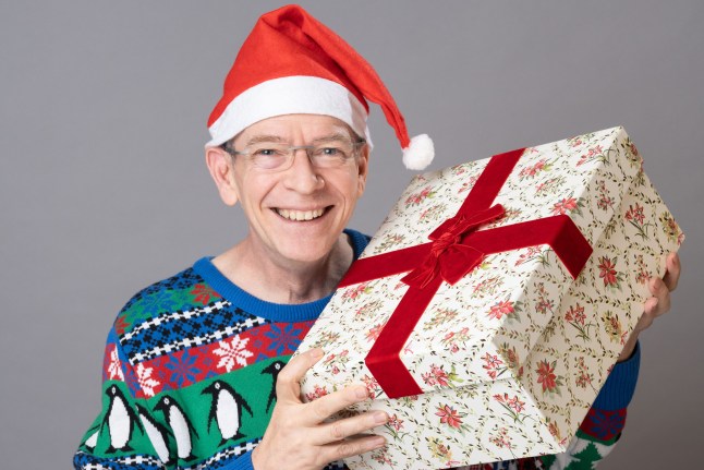 Ian Beale holding a present in EastEnders