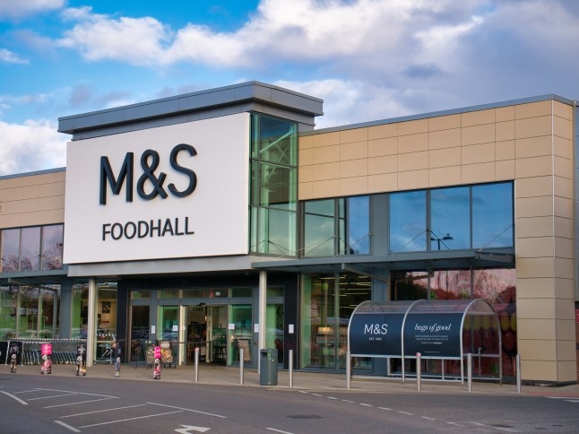 The frontage and barnd logo of a Marks & Spencer Foodhall, taken in a local retail park on Wirral, UK on a sunny afternoon