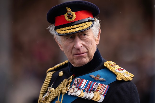 King Charles III appearing stern while wearing Royal military uniform