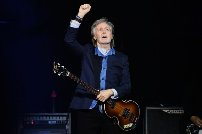 Sir Paul McCartney performing during his 'Got Back' tour in London with his fist in the air