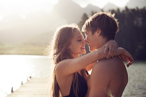 Young couple about to kiss in a natural environmen