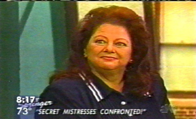 A Jerry Springer Show guest was murdered while watching a tape of herself on the programme. Nancy Campbell Panitz (pictured here on the show), 52, appeared on the show, accused of stalking her ex-husband and his new wife. The programme was taped in May and broadcst on Monday. It brought Mrs Campbel Panitz face-to-face with her love rival and revealed how the trio were in dispute over a house-where Mrs Campbell Panitz was later found killed. Sarasota police have issued arrest warrants for Mr Ralf Panitz and wife Eleanor. SPLASH Ref: KS 260700