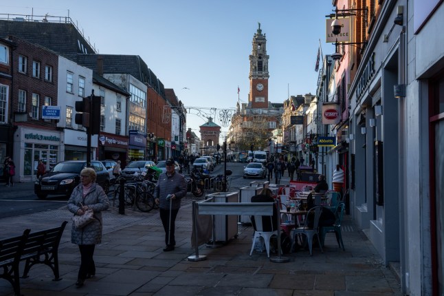 COLCHESTER, ENGLAND - NOVEMBER 25: People pass along the High Street on November 25, 2022 in Colchester, United Kingdom. The former Roman settlement of Colchester was named one of eight towns to be made cities to mark the Queen's Platinum Jubilee. (Photo by Carl Court/Getty Images)