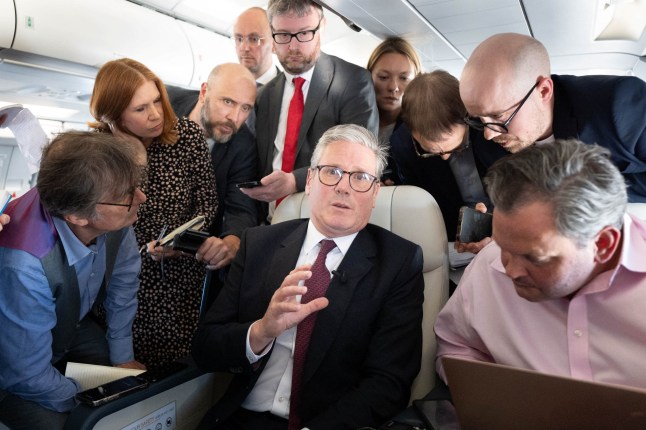 Britain's Prime Minister Keir Starmer talks to the media on board his plane as he flies to Washington DC. Picture date: Thursday September 12, 2024. Stefan Rousseau/Pool via REUTERS