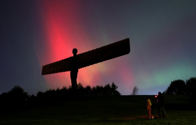 Northern Lights, also known as aurora borealis, are seen at the Angel of the North in Gateshead, Britain, October 10, 2024. REUTERS/Lee Smith