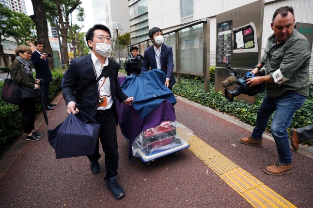 Prosecutors with the evidence head to the Chiba District Court on the opening day of the trial over Australian citizen Donna Nelson for allegedly attempting to import drugs into Japan Monday, Nov. 18, 2024, in Chiba, east of Tokyo. (AP Photo/Eugene Hoshiko) 14156273