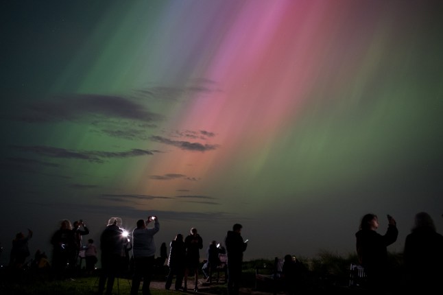 2024 YEAR IN REVIEW ??? NEWS - WHITLEY BAY, ENGLAND - MAY 10: People visit St Mary's lighthouse in Whitley Bay to see the aurora borealis, commonly known as the northern lights, on May 10, 2024 in Whitley Bay, England. The UK met office said a strong solar storm may allow northern parts of the UK the chance to see displays of aurora. (Photo by Ian Forsyth/Getty Images)